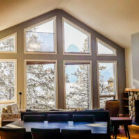 Living,room,with,wide,big,windows,typical,for,mountain,style